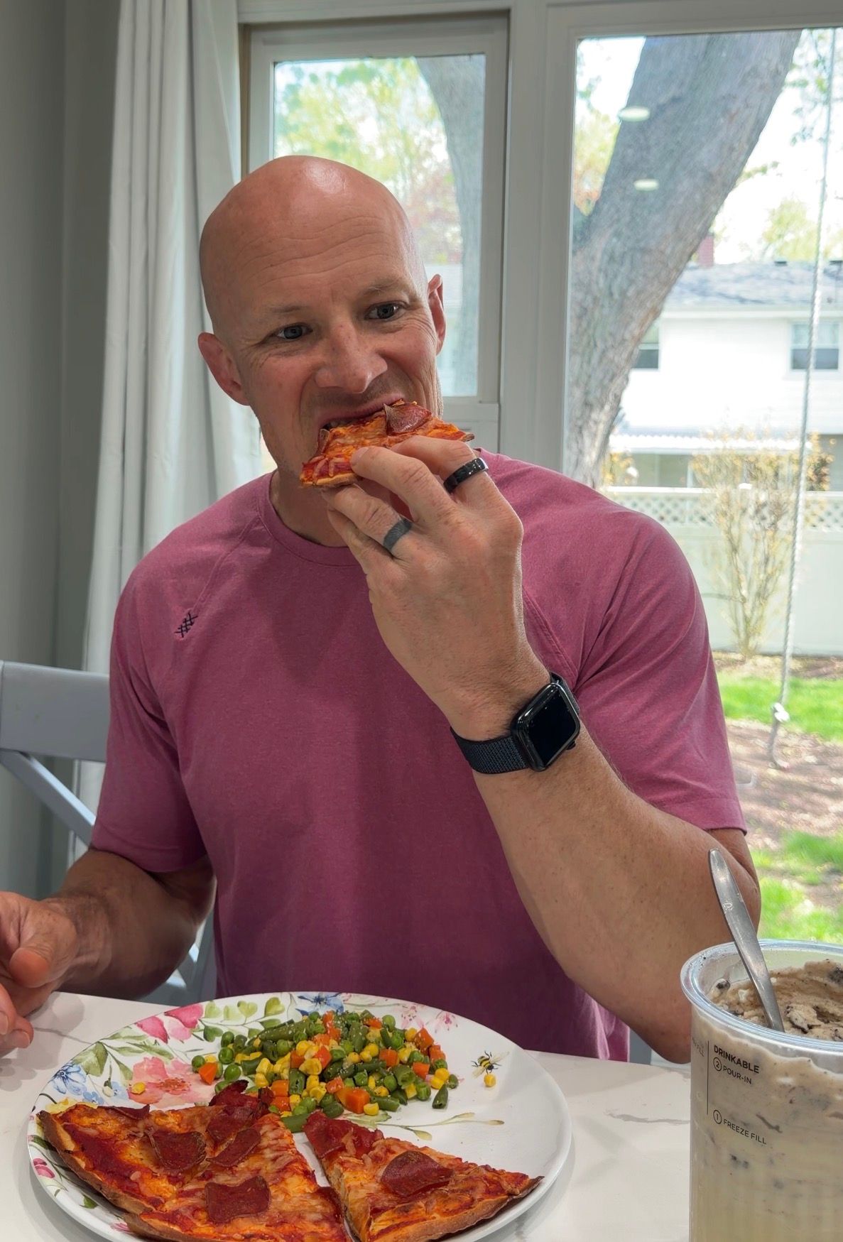 Coach is smiling and having a plate with three toasts, bluberries, one egg, one tangerine and syrup on the side