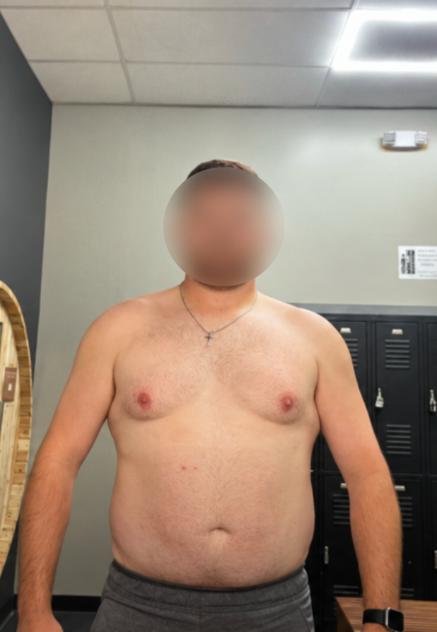 A shirtless man with a blurred face stands in a gym locker room for a fitness progress check.