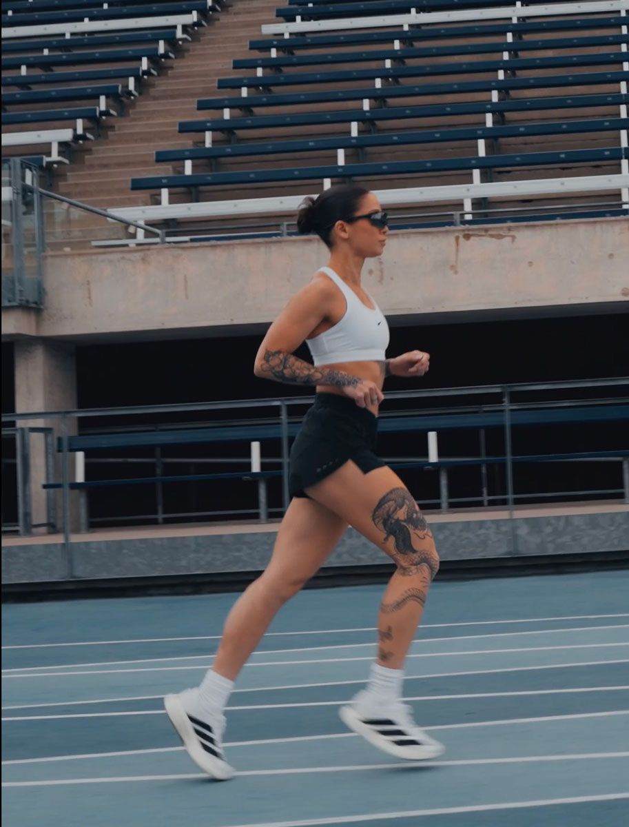 The coach is posing while running.
