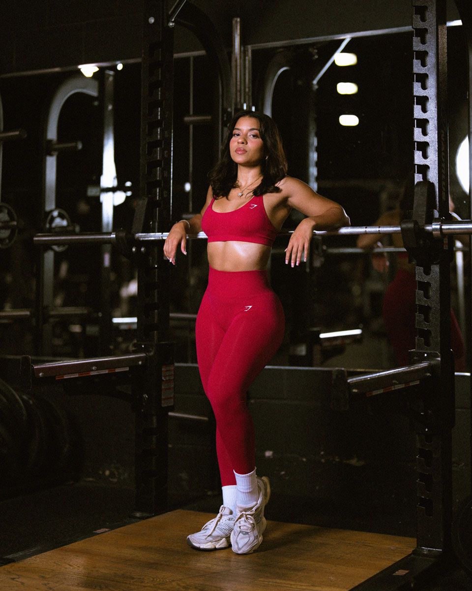 The coach is posing at the gym.