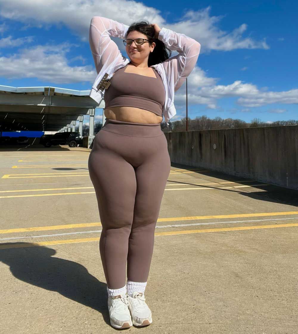 The coach is posing with her confidence.