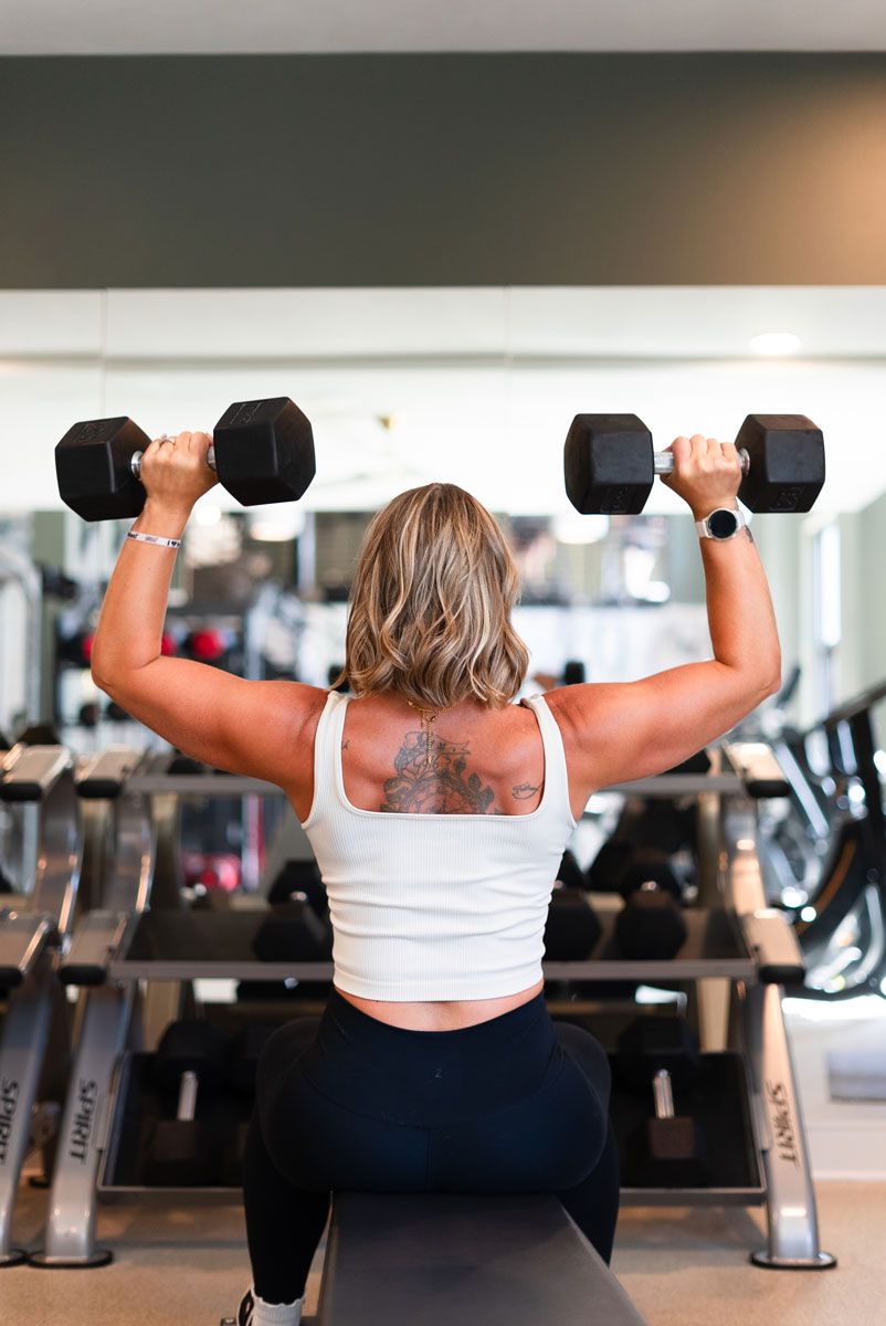 The coach is showing her back muscle.