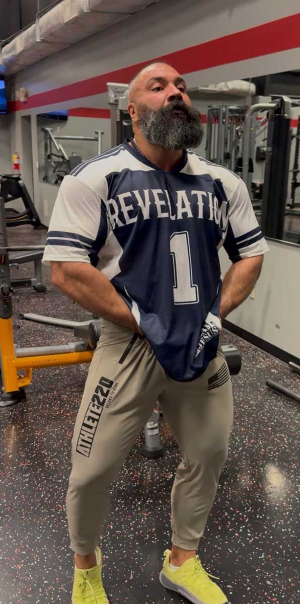 Coach is doing squat with a barbell.