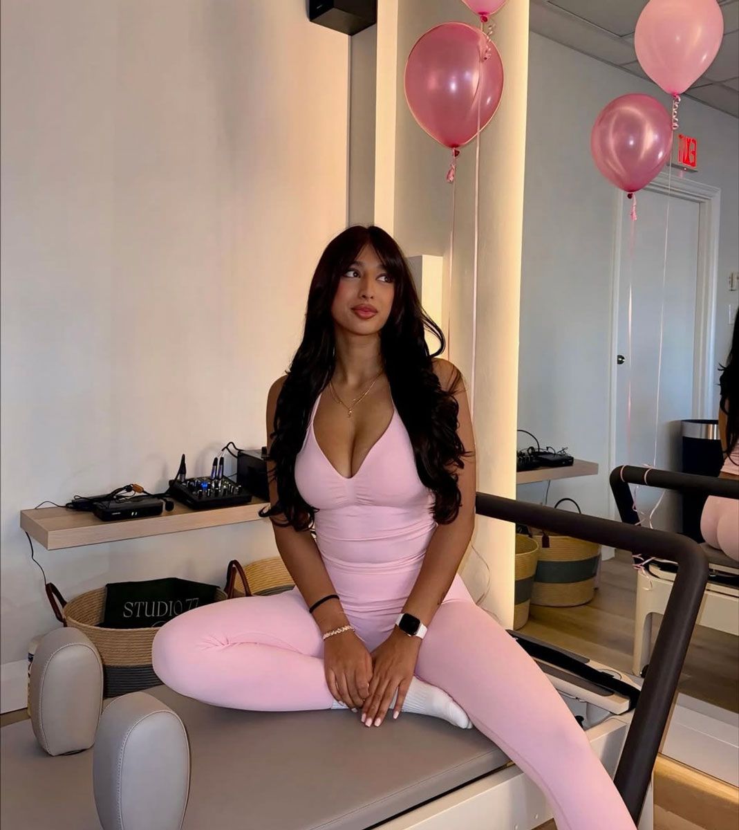 The coach is posing with the balloon.