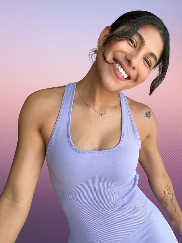 Coach Iman smiling in a lavender workout set