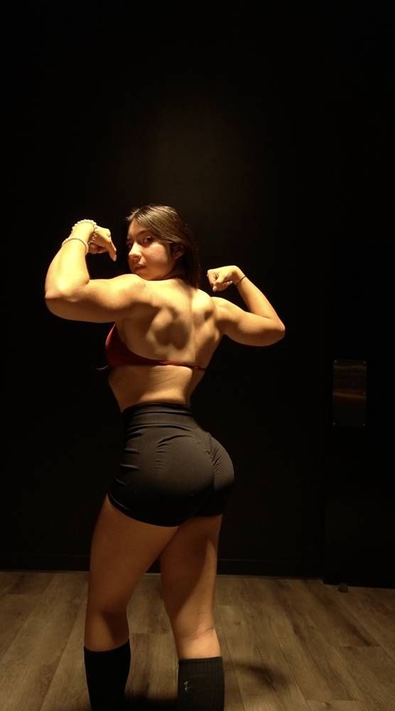 Kacey hitting a back double biceps pose